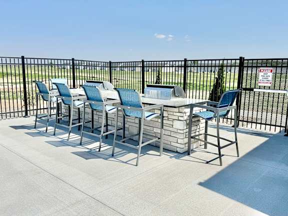 A row of chairs and tables are set up on a patio.