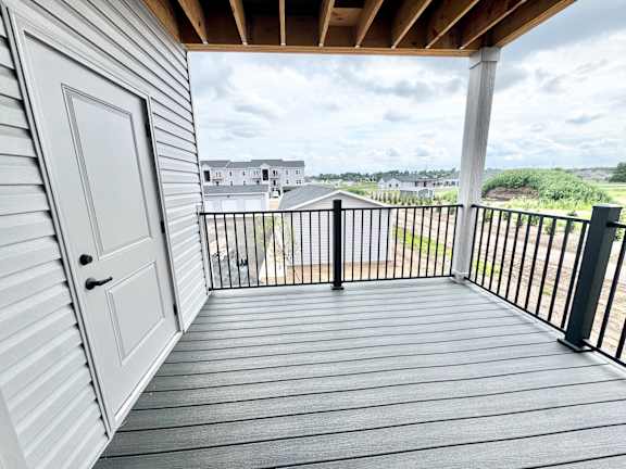 A white door is on the left of a balcony.