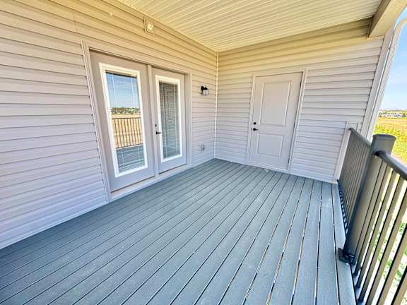 A balcony with a sliding door and a window.