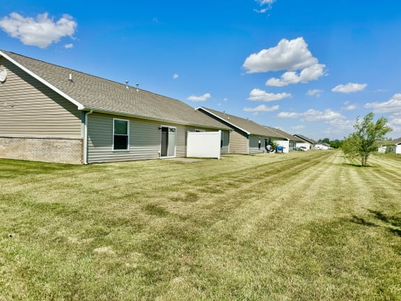 a row of houses with grass in front of them at Hawthorne Properties in Lafayette, IN 47905
