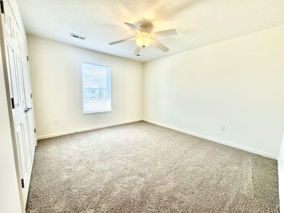 an empty room with carpet and a ceiling fan at Hawthorne Properties in Lafayette, IN 47905