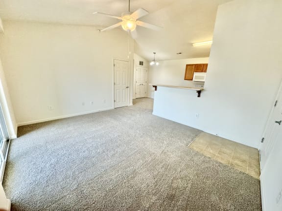the living room of an empty house with a ceiling fan at Hawthorne Properties in Lafayette, IN 47905