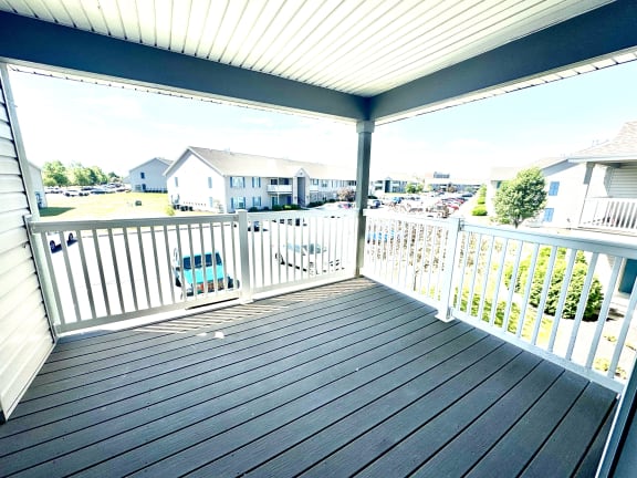 a deck with a view of a parking lot and houses at Hawthorne Properties in Lafayette, IN 47905