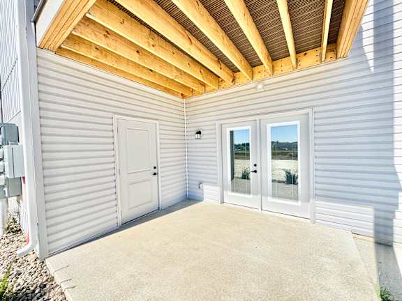A house with a white exterior and a wooden ceiling.
