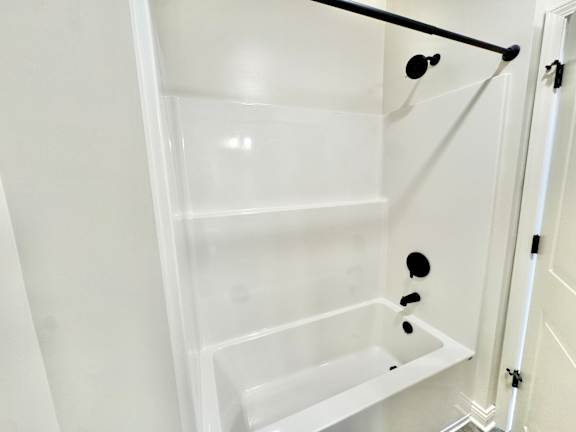 A white empty shelving unit with black handles.