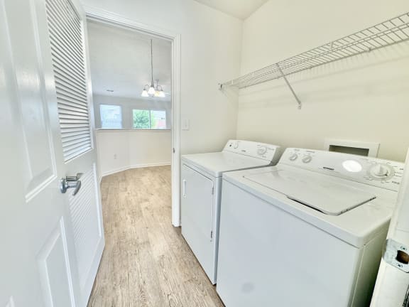 a laundry room with a washer and dryer and a door to a closet at Hawthorne Properties in Lafayette, IN 47905