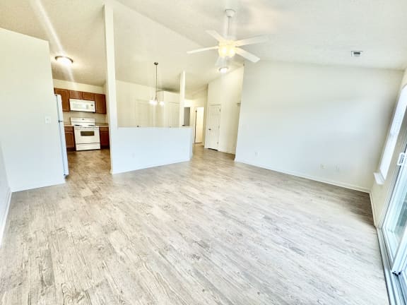 an empty living room and kitchen with a ceiling fan at Hawthorne Properties in Lafayette, IN 47905