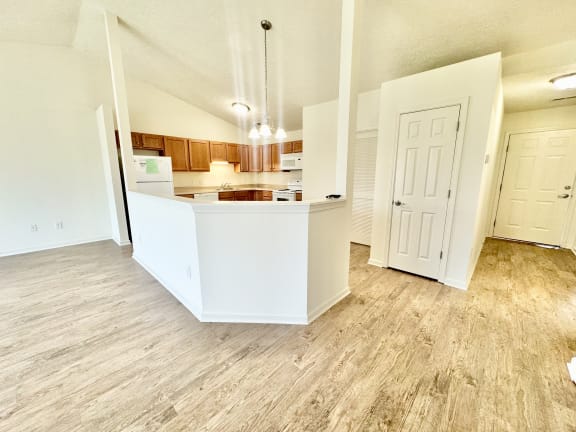an open kitchen and living room with wood flooring at Hawthorne Properties in Lafayette, IN 47905