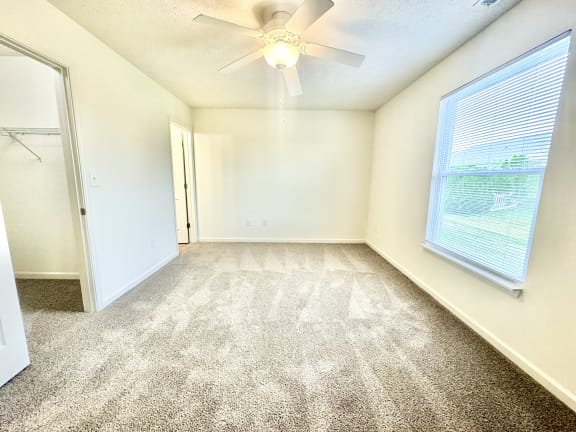 an empty room with a ceiling fan and a window at Hawthorne Properties in Lafayette, IN 47905
