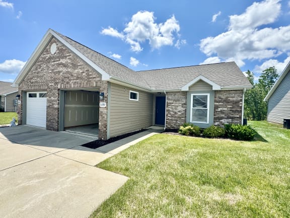 a house with a garage and a lawn at Hawthorne Properties in Lafayette, IN 47905