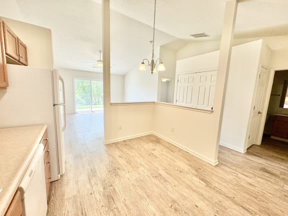 an empty kitchen and living room with a refrigerator at Hawthorne Properties in Lafayette, IN 47905