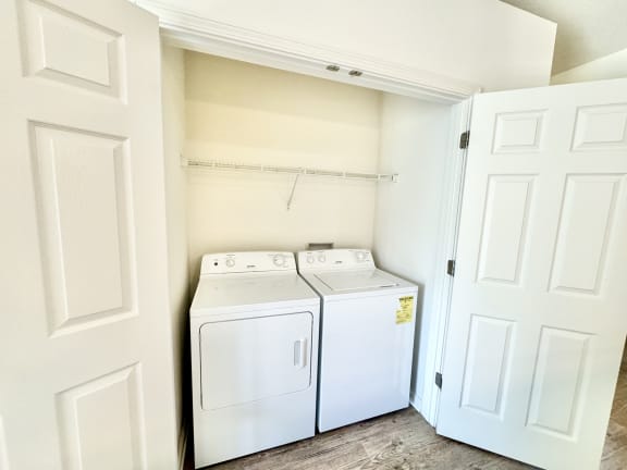 a washer and dryer in a laundry room with white doors at Hawthorne Properties in Lafayette, IN 47905