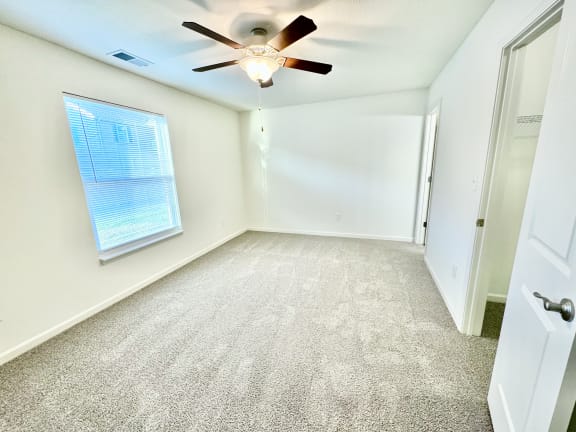 an empty room with a ceiling fan and a window at Hawthorne Properties in Lafayette, IN 47905