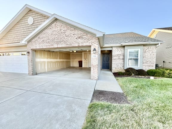 a house with a driveway and a garage door at Hawthorne Properties in Lafayette, IN 47905