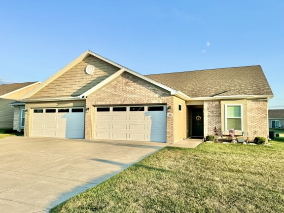 a house with a driveway and a garage door at Hawthorne Properties in Lafayette, IN 47905