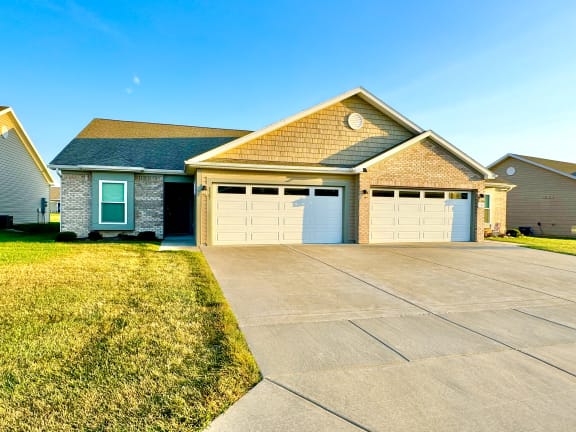a house with a driveway and a garage door at Hawthorne Properties in Lafayette, IN 47905