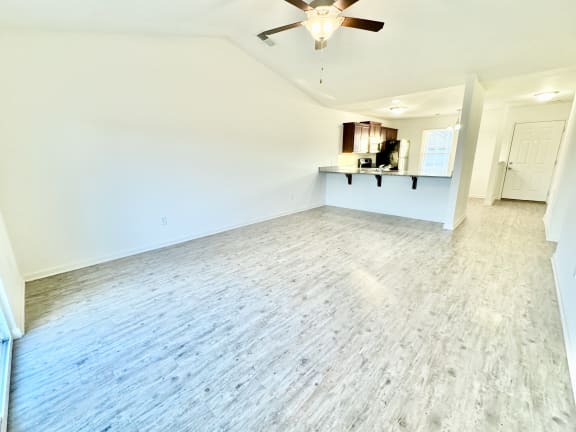 an empty living room with white walls and a ceiling fan at Hawthorne Properties in Lafayette, IN 47905