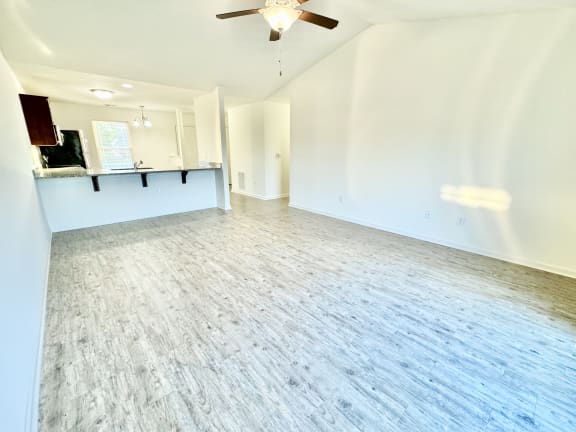 an empty living room with white walls and a ceiling fan at Hawthorne Properties in Lafayette, IN 47905