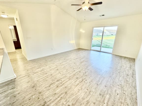an empty living room with white walls and a ceiling fan at Hawthorne Properties in Lafayette, IN 47905