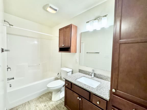 a bathroom with a sink toilet and a mirror at Hawthorne Properties in Lafayette, IN 47905