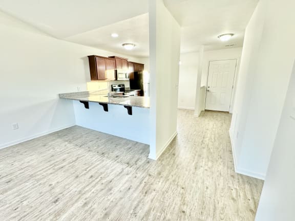 a view of a kitchen and living room in a new home at Hawthorne Properties in Lafayette, IN 47905