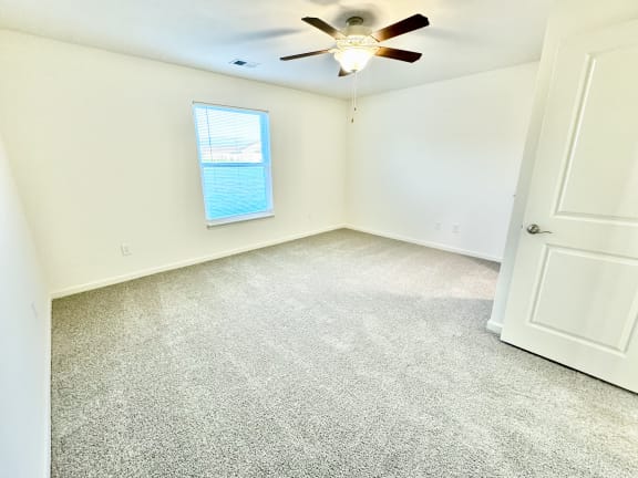 an empty room with a ceiling fan and a window at Hawthorne Properties in Lafayette, IN 47905