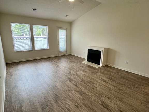 A room with a fireplace and a window.