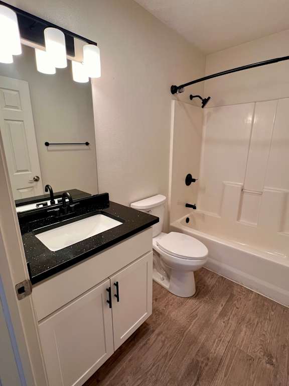 A bathroom with a sink, toilet, and bathtub.