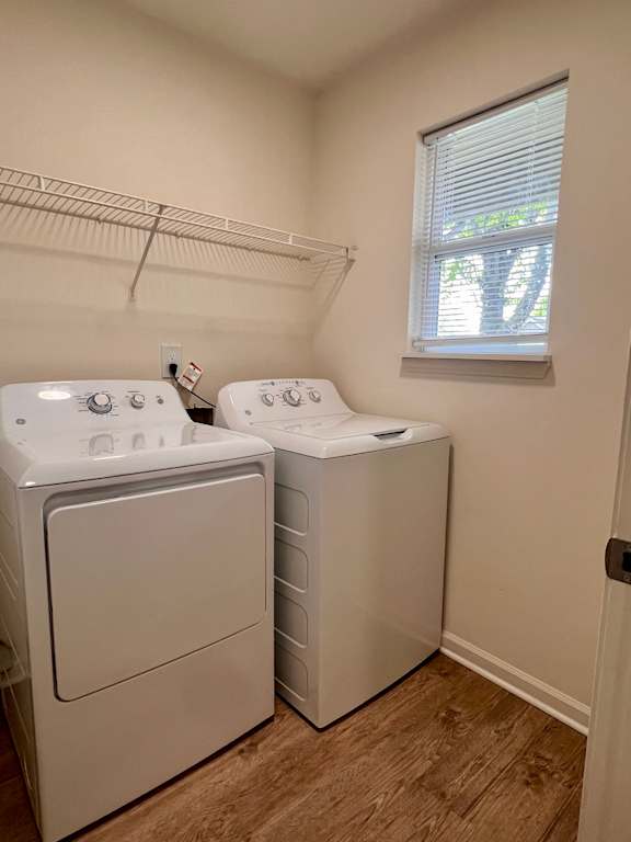 Two white front loading washing machines in a laundry room.