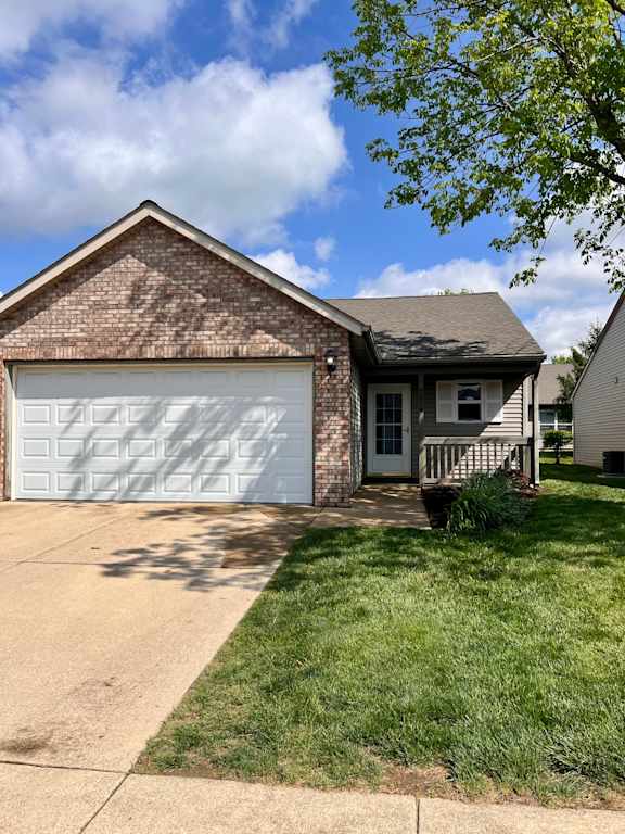 A house with a white garage door and a brown roof.