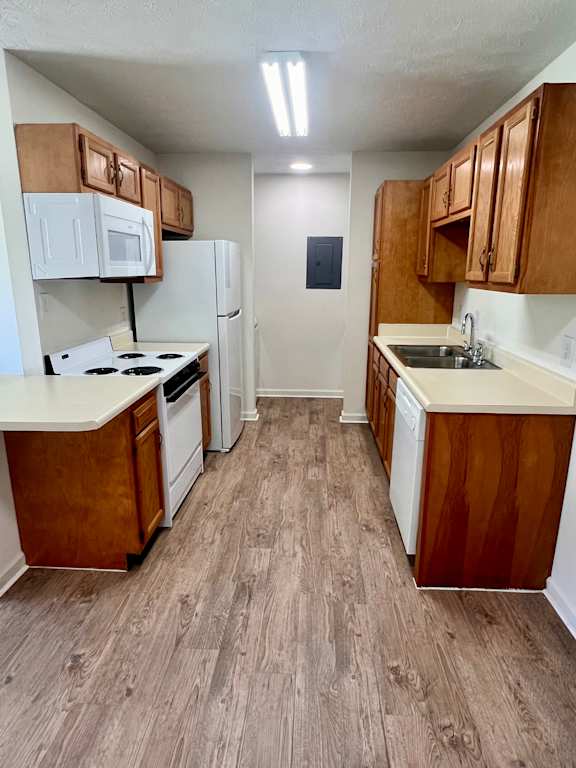 A kitchen with wooden cabinets and a white refrigerator.