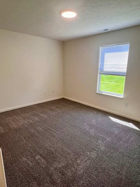 A room with a carpeted floor and a window.
