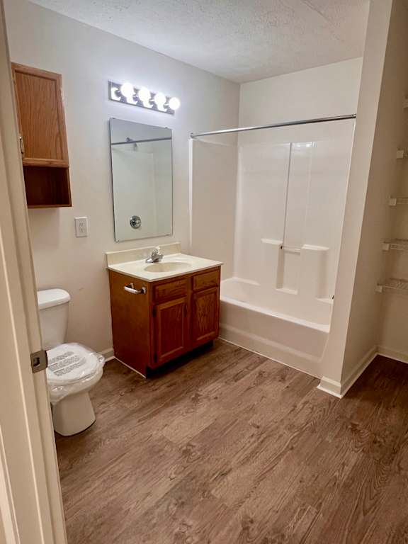 A bathroom with a toilet, sink, and medicine cabinet.