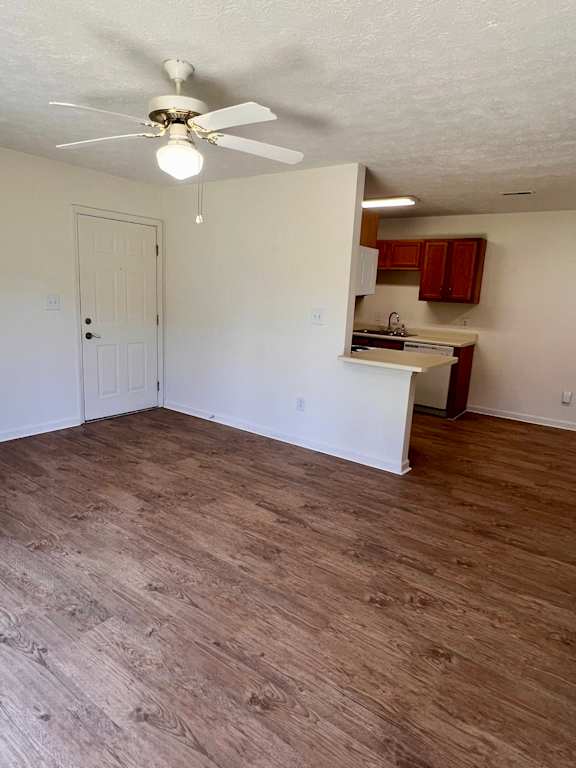A room with a ceiling fan and wooden flooring.