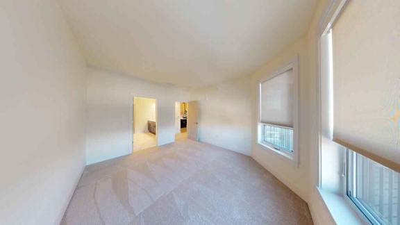A room with a bed and a window.