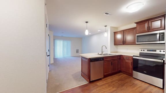 a kitchen with wooden cabinets and a stove and a microwave