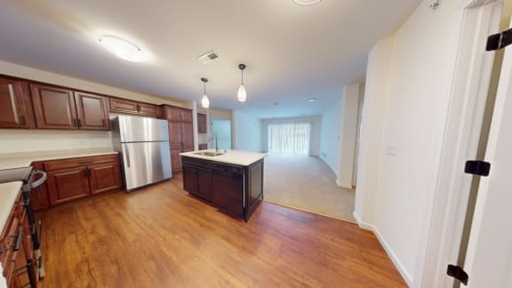 a kitchen and living room with wood flooring and