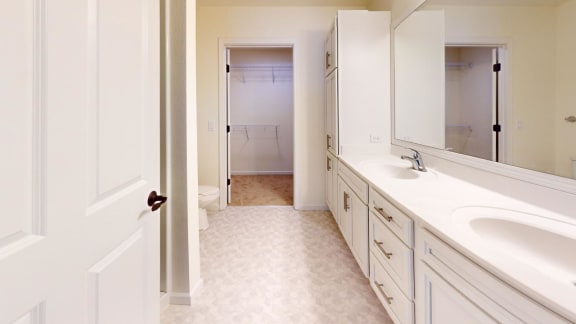 a bathroom with two sinks and a mirror
