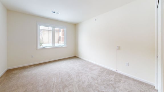 a room with carpet and a window