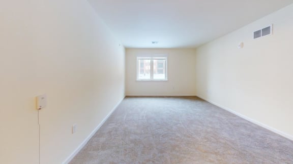 a room with carpet and a window