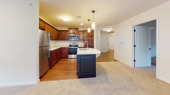 a kitchen with wooden cabinets and stainless steel appliances