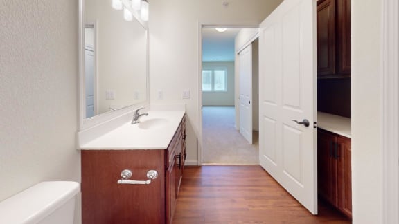 a bathroom with a sink and a door into a hallway
