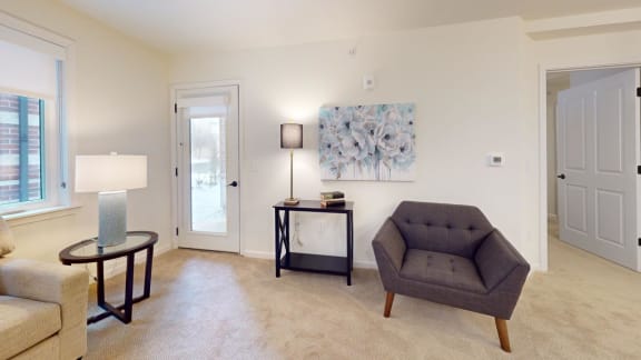 a living room with a couch and a chair and a table