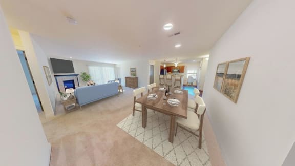 a dining room and living room with a table and chairs