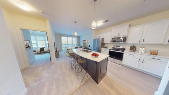 an open kitchen with a large island and white cabinets