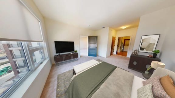 a bedroom with a bed and a tv