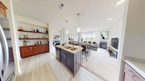 a kitchen and living room with a counter top in a house