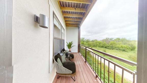 a balcony with a couch and a cat on it