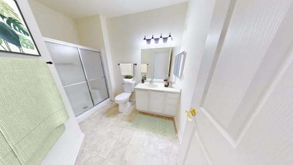 a white bathroom with a shower toilet and sink