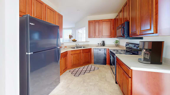 a kitchen with stainless steel appliances and wooden cabinets